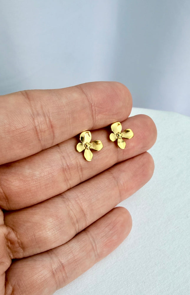 Gold Flower Drop Hook Earrings held in an open palm to showcase their featherlight scale and radiant 18k gold shine in natural light.