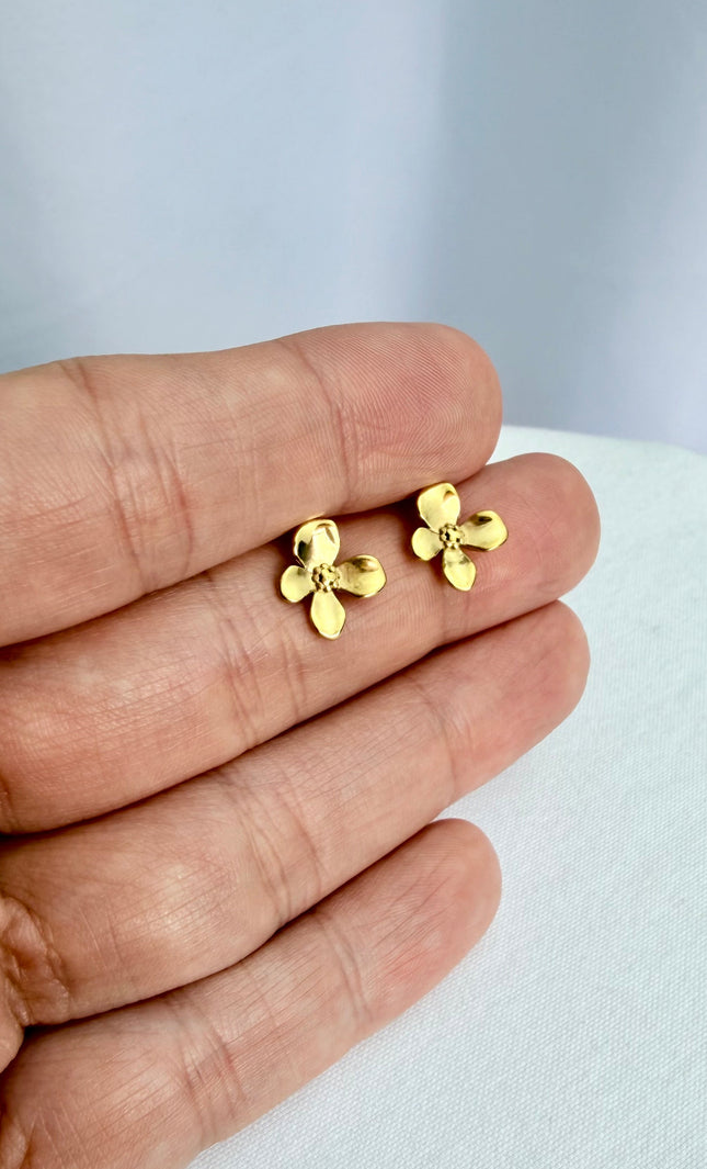 Gold Flower Drop Hook Earrings held in an open palm to showcase their featherlight scale and radiant 18k gold shine in natural light.