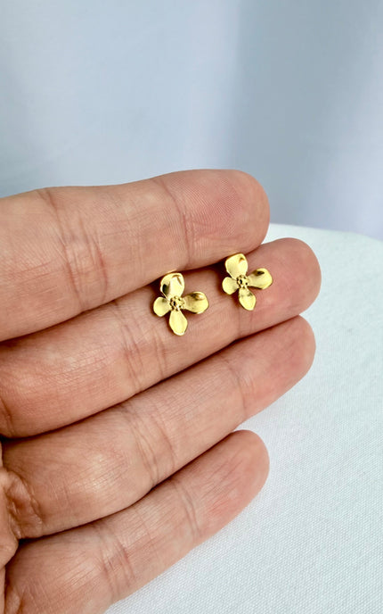 Gold Flower Drop Hook Earrings held in an open palm to showcase their featherlight scale and radiant 18k gold shine in natural light.