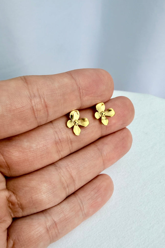 Gold Flower Drop Hook Earrings held in an open palm to showcase their featherlight scale and radiant 18k gold shine in natural light.