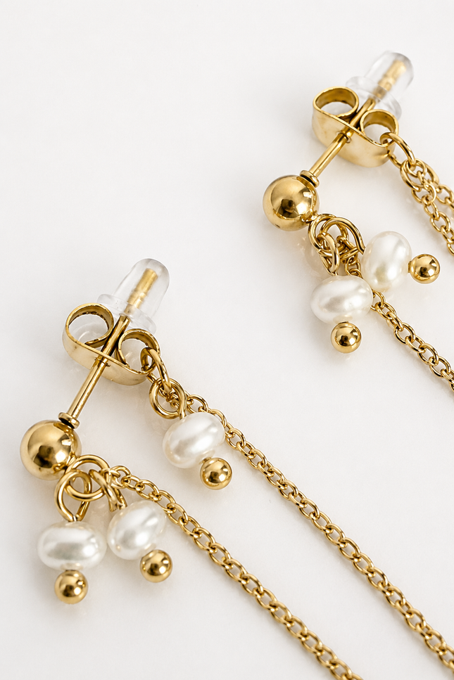 Gold dangle earrings with barbell studs, small pearl beads, and chain drops on a clean white background.