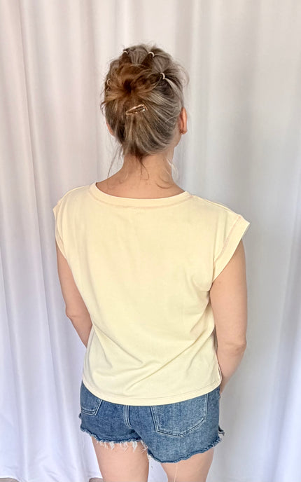 Back view of a soft French terry top with cap sleeves and a relaxed boxy silhouette.