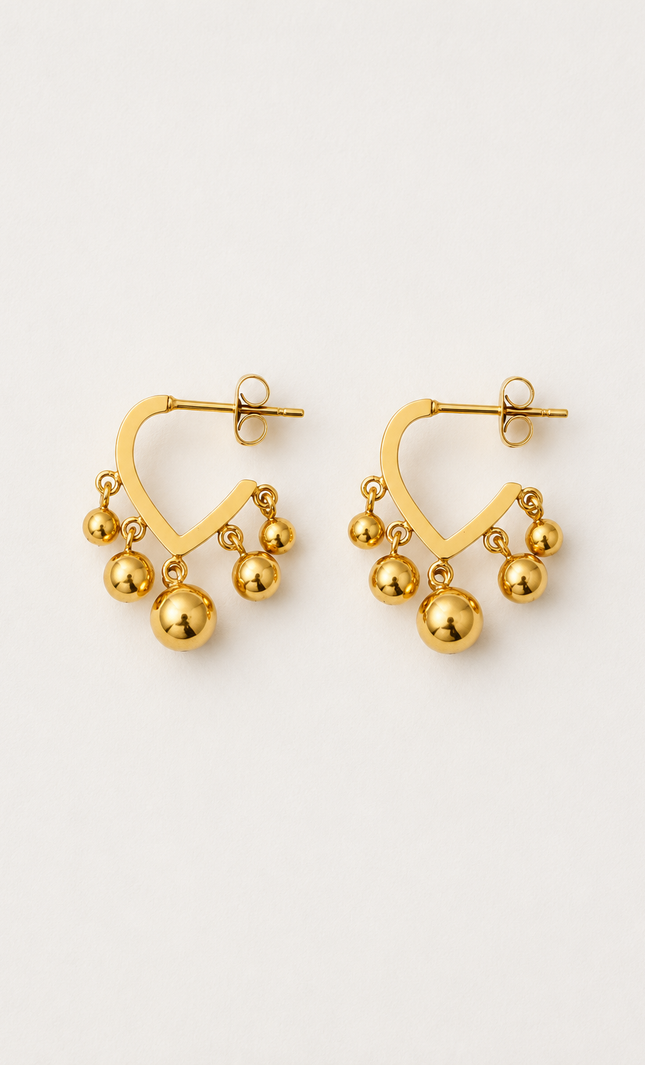 Open V-shaped 18k gold hoop earrings with polished dangling gold ball beads on a light neutral background.