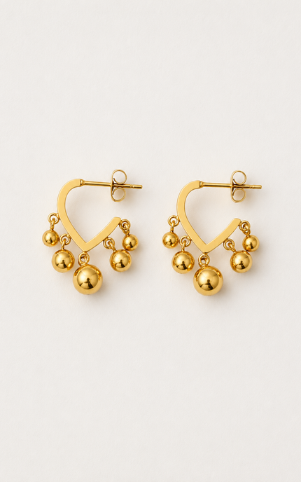 Open V-shaped 18k gold hoop earrings with polished dangling gold ball beads on a light neutral background.