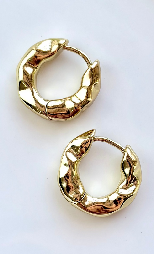 Pair of gold hoop earrings on a white background