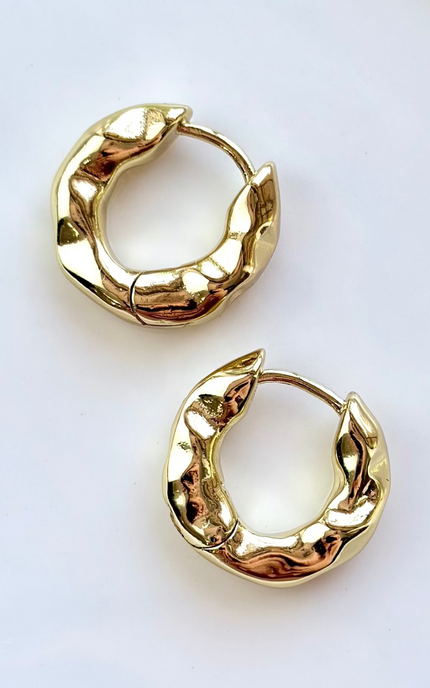 Pair of gold hoop earrings on a white background