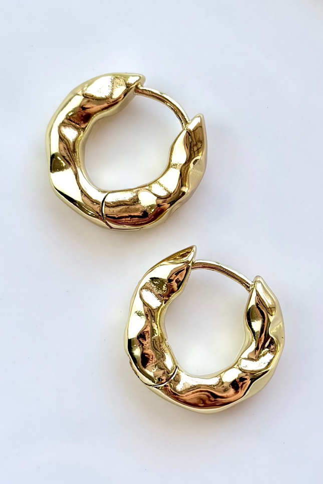 Pair of gold hoop earrings on a white background