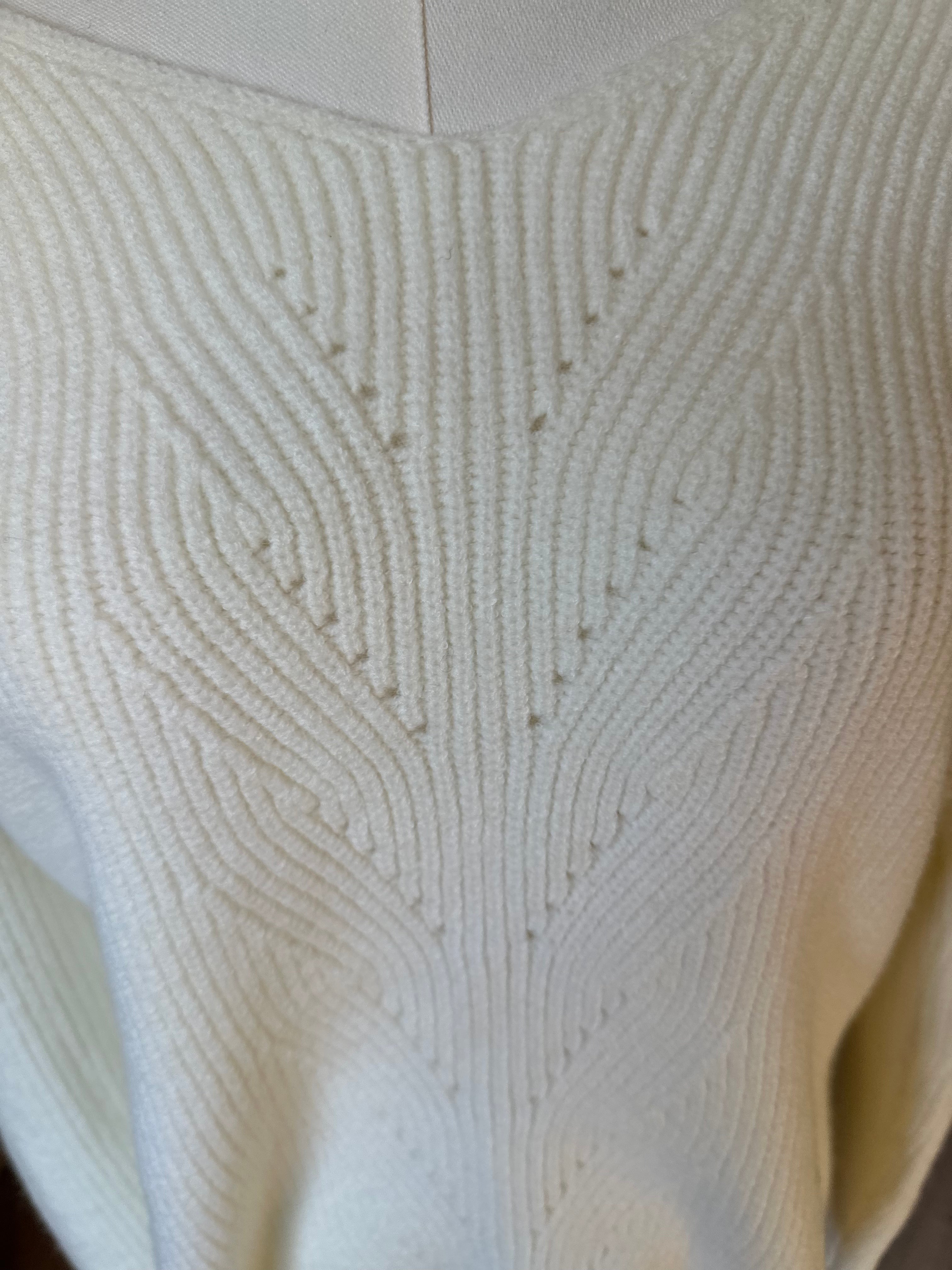 Off-white ribbed sweater with lace-trim V-neckline and oversized bow detail draping down the back, photographed on a Soft Linen background for Justyna Grace Boutique.