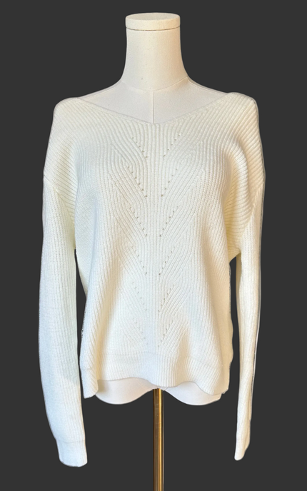 Off-white ribbed sweater with lace-trim V-neckline and oversized bow detail draping down the back, photographed on a Soft Linen background for Justyna Grace Boutique.