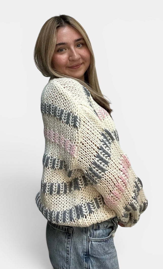Cozy ivory striped sweater with a chunky knit texture and drop shoulders.