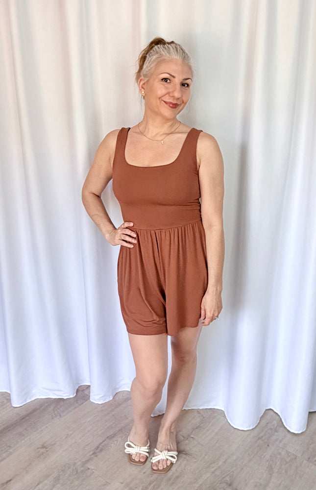 Hazelnut sleeveless romper with square neckline and shirred waist detail.