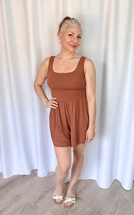 Hazelnut sleeveless romper with square neckline and shirred waist detail.