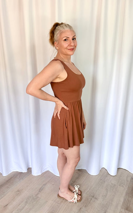 Side view of a hazelnut romper showing the flattering waistline and easy fit.