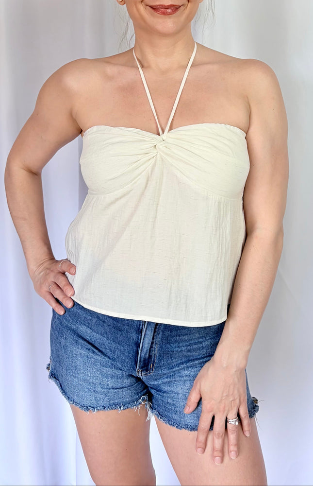 Ivory sleeveless halter top with subtle bead accents and lightweight comfort.