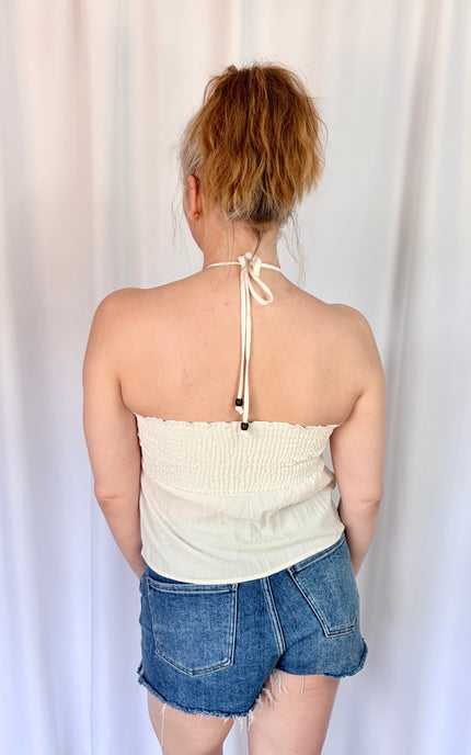 Back view of a soft ivory halter top with a flowy fit and breathable Tencel blend.