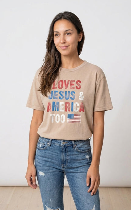 Woman wearing a beige t-shirt with 'LOVES JESUS & AMERICA TOO' text and an American flag graphic.