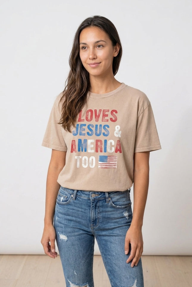 Woman wearing a beige t-shirt with 'LOVES JESUS & AMERICA TOO' text and an American flag graphic.
