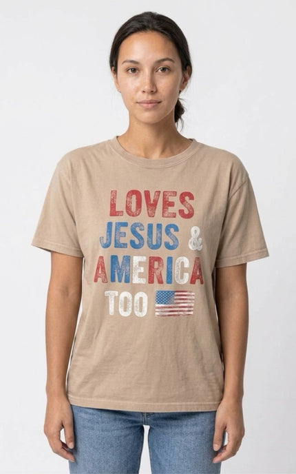 Person wearing a beige t-shirt with 'LOVES JESUS & AMERICA TOO' text and American flag design.