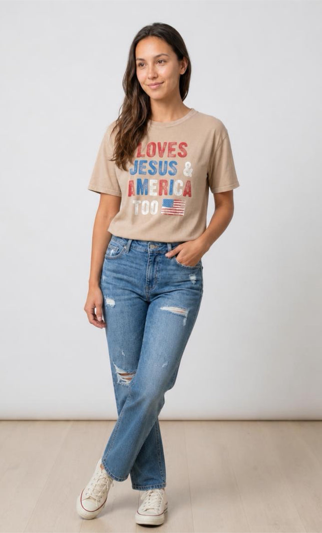 Woman wearing a beige t-shirt with text and jeans on a plain background