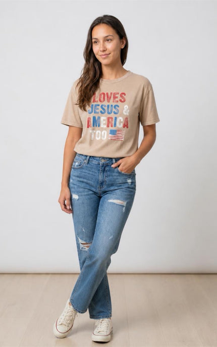Woman wearing a beige t-shirt with text and jeans on a plain background