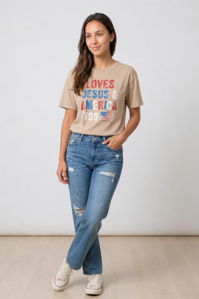 Woman wearing a beige t-shirt with text and jeans on a plain background
