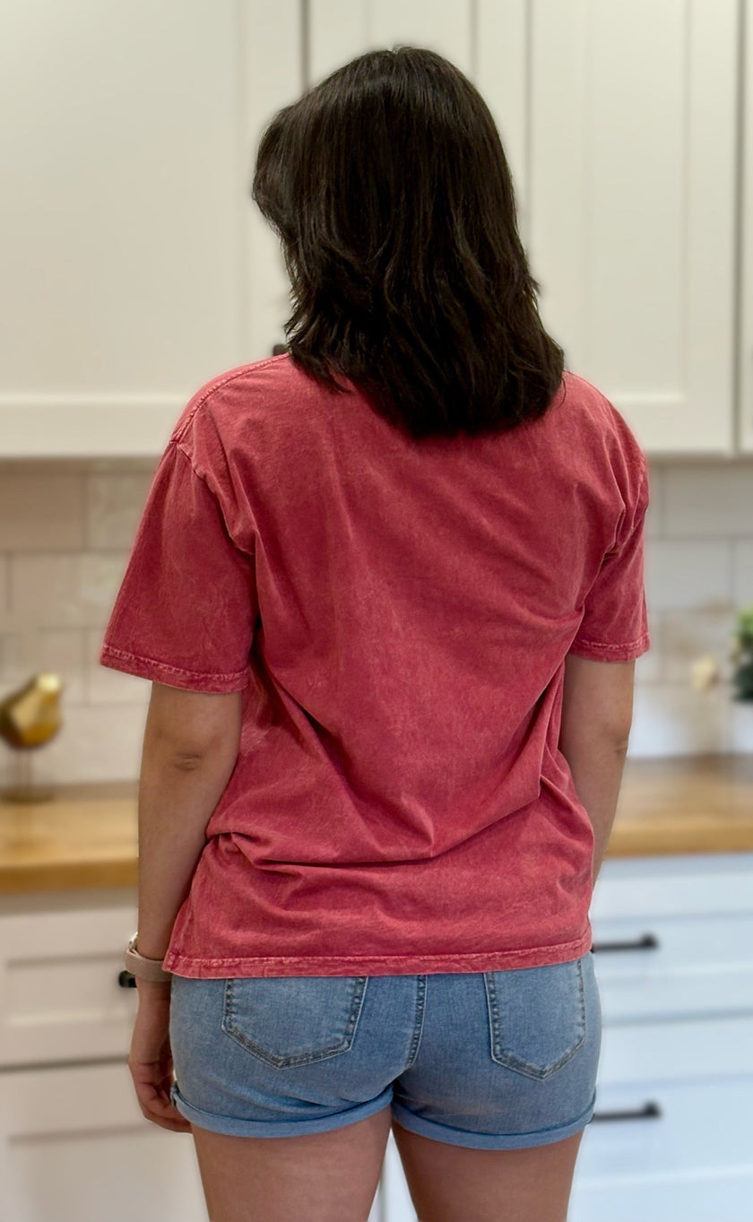 Red mineral-wash “Jesus Is King” graphic tee with relaxed unisex fit and vintage garment-dyed finish.