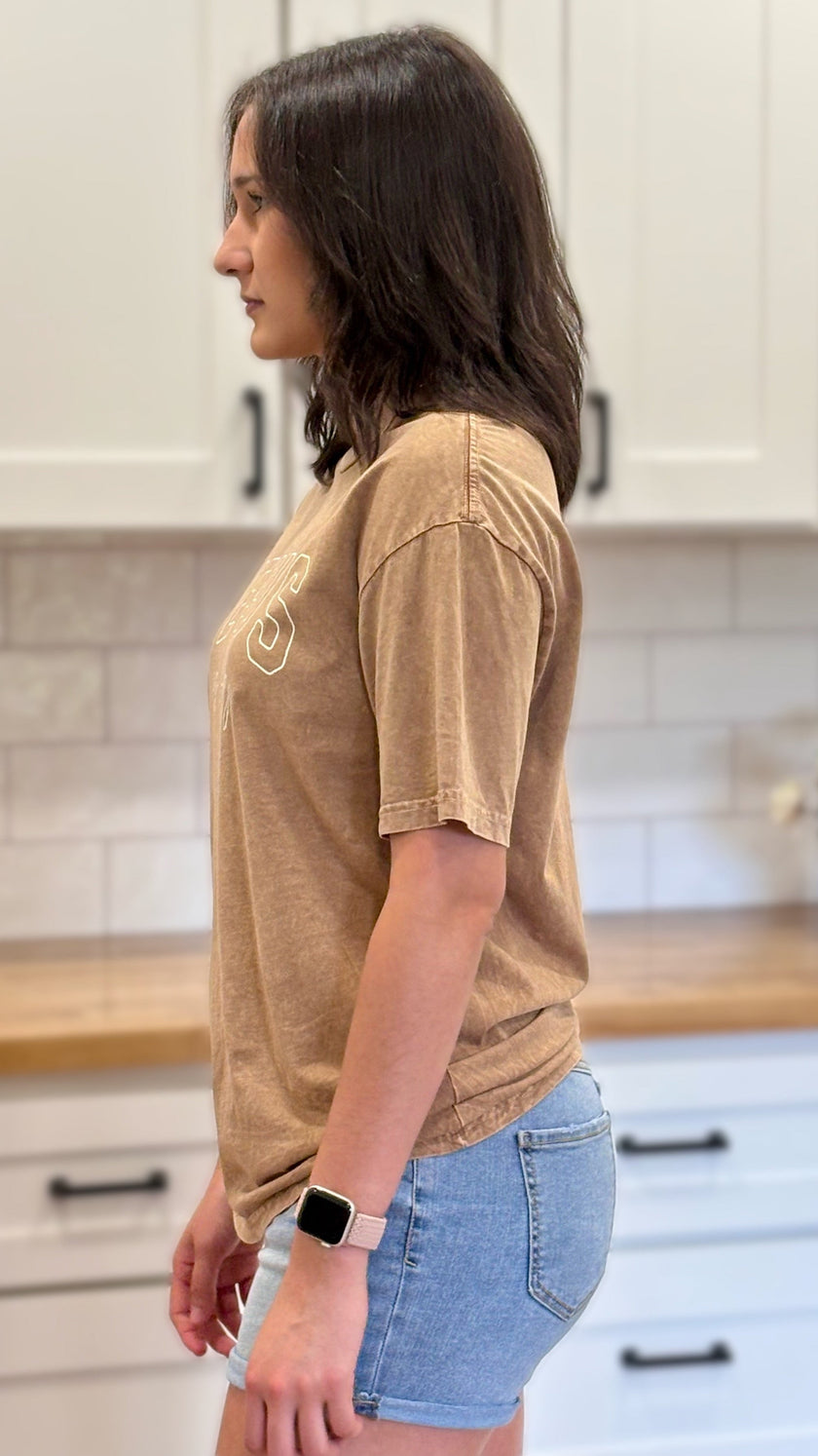 Goldmineral-wash “Jesus Is King” graphic tee with relaxed unisex fit and vintage garment-dyed finish.