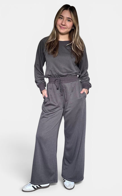 Dark gray off-the-shoulder knit jumpsuit with a relaxed silhouette and soft stretch fabric.