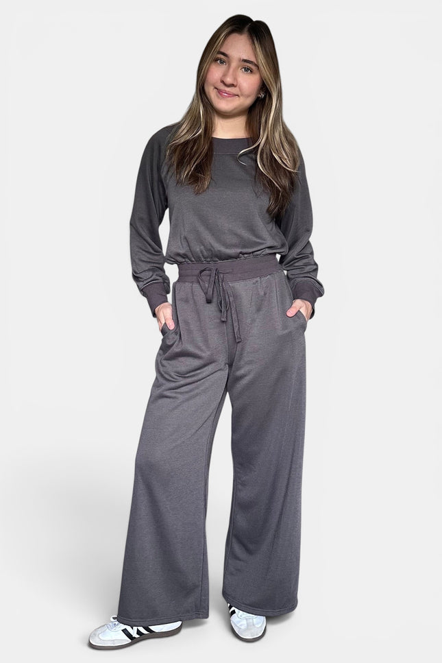 Dark gray off-the-shoulder knit jumpsuit with a relaxed silhouette and soft stretch fabric.