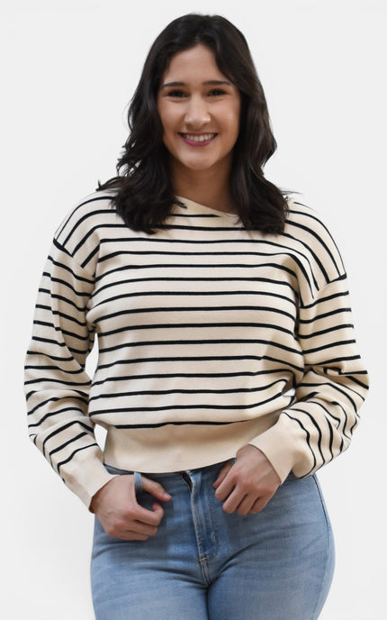 Front view of women's asymmetric boat neck long sleeve knit top.