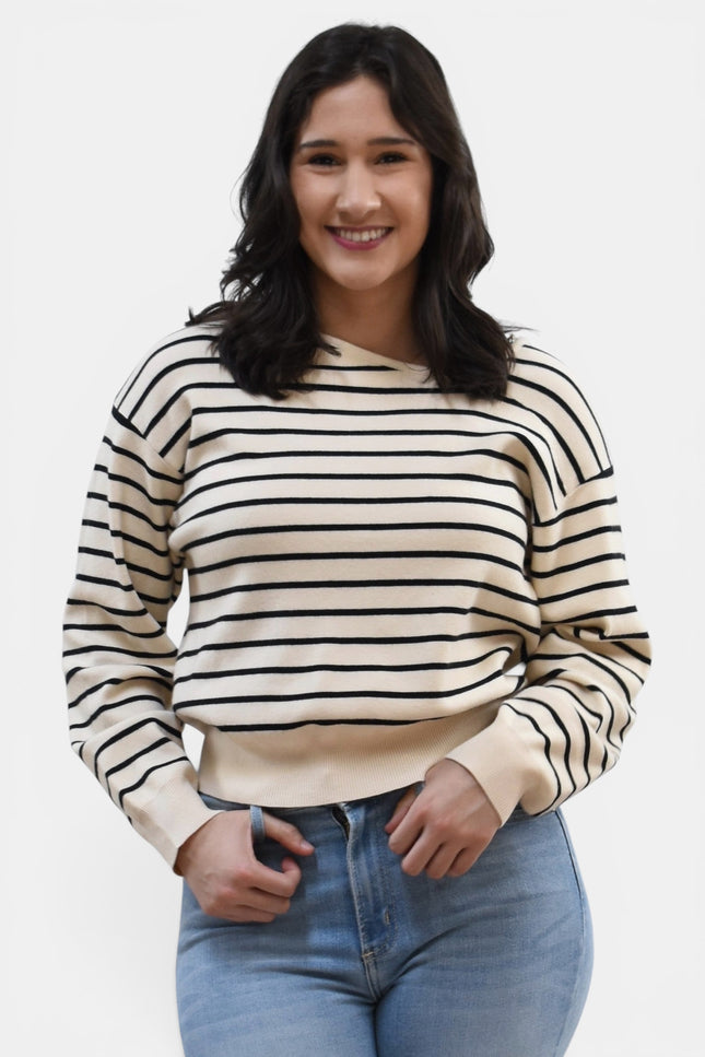 Front view of women's asymmetric boat neck long sleeve knit top.