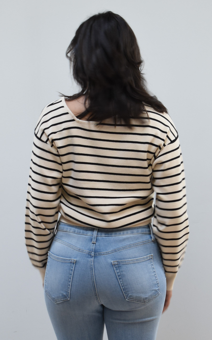Back view of women's asymmetric boat neck long sleeve knit top.