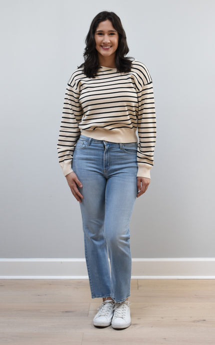 Justyna Top on soft linen background, featuring a soft knit long sleeve and asymmetric boat neckline.