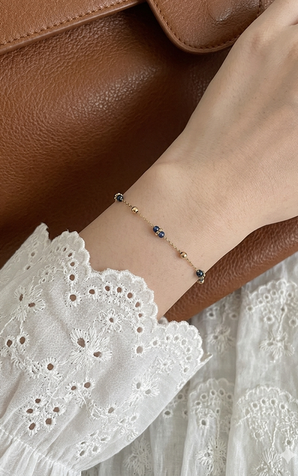 Lapis and gold bead bracelet worn alone for a soft, effortless everyday look.