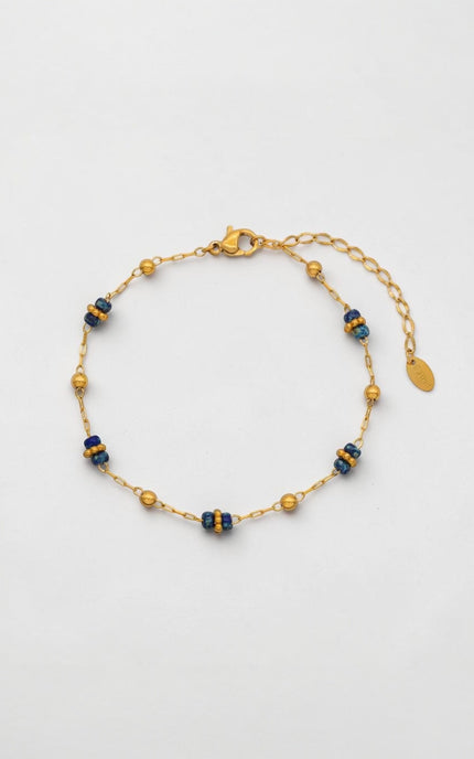 Front view of dainty lapis lazuli and gold bead station bracelet on a delicate paperclip chain.