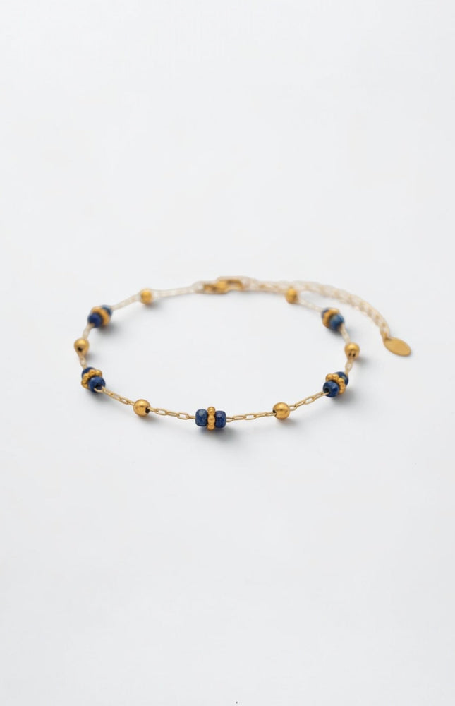 Side profile showing alternating lapis clusters and gold beads along the slim chain.