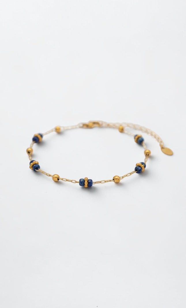 Side profile showing alternating lapis clusters and gold beads along the slim chain.