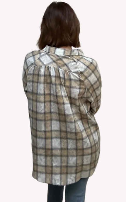 Person wearing a plaid shirt from behind on a plain background