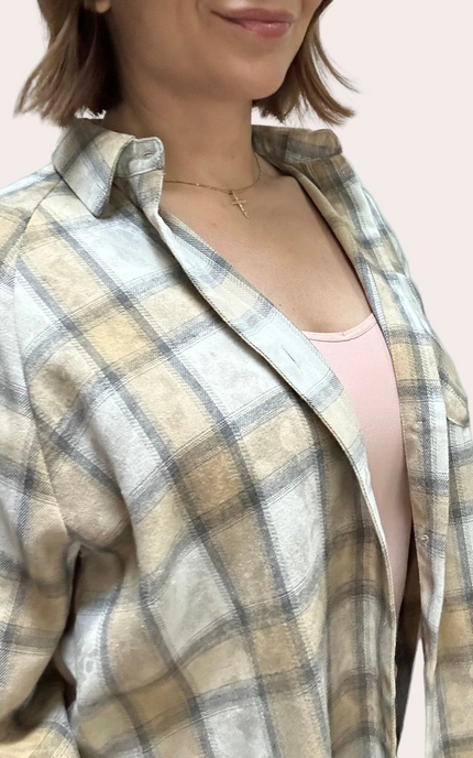 Plaid shirt worn by a person on a light pink background