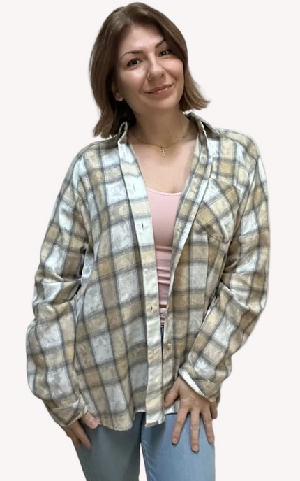 Woman wearing a plaid shirt against a plain background