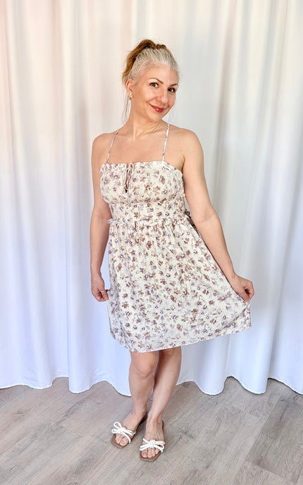 Feminine lavender floral mini dress with pockets, flutter sleeves, and a romantic floral print.