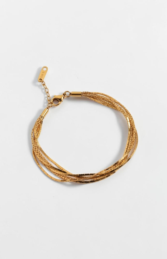 Top down view of minimal layered gold chain bracelet with soft drape and lightweight design.