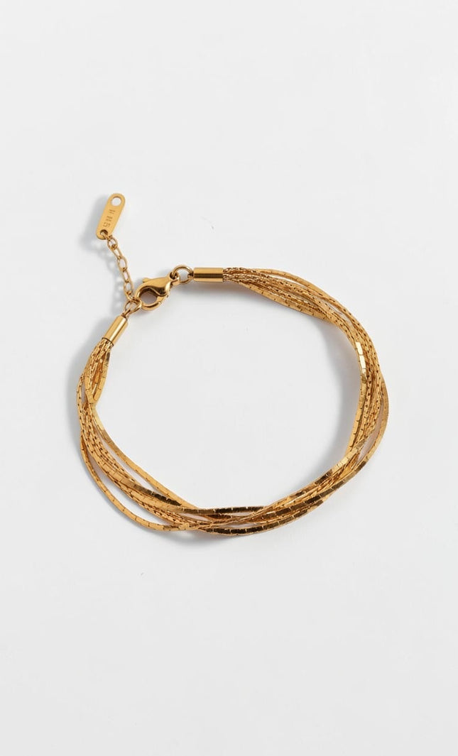 Top down view of minimal layered gold chain bracelet with soft drape and lightweight design.