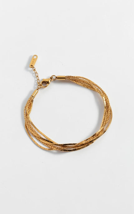 Top down view of minimal layered gold chain bracelet with soft drape and lightweight design.