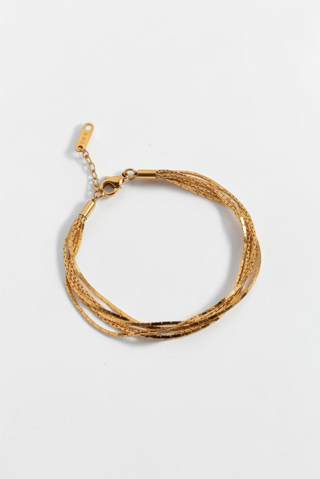 Top down view of minimal layered gold chain bracelet with soft drape and lightweight design.