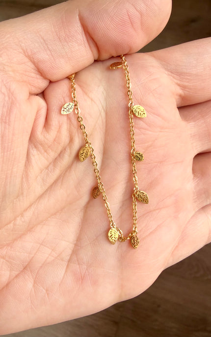 Hypoallergenic gold choker necklace with tiny botanical leaf charms