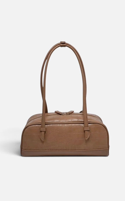 A brown textured leather duffel bag with double top handles, shown against a plain light gray background.
