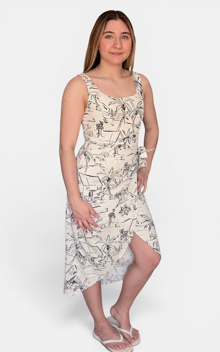 A sleeveless midi dress with a black and gray botanical line-art print on a warm cream background, paired with white flip-flop sandals against a light gray studio background.