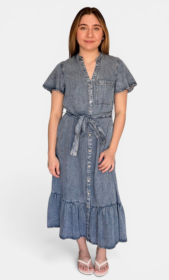 A short-sleeve tencel denim midi dress with a tie waist, button front, and ruffled hem, photographed against a plain light gray studio background.