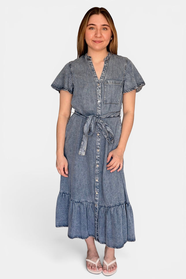 A short-sleeve tencel denim midi dress with a tie waist, button front, and ruffled hem, photographed against a plain light gray studio background.